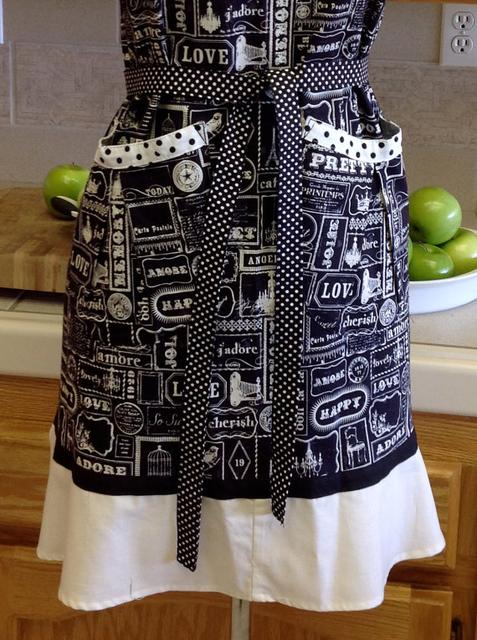V-Neck Flirty Apron -  Language of Love.  Black and white vintage print says "love, amore, jadore, bella, ect. mixed with polka-dot trim.