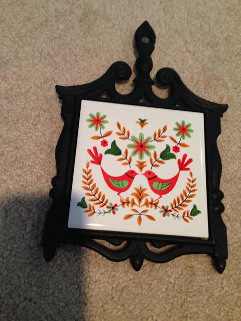 cast iron trivet with scandinavian bird tile design ceramic center